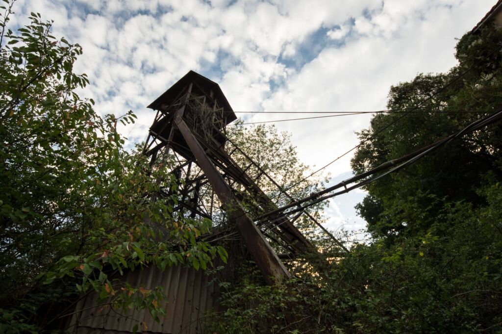Zeigt den Förderturm von unten in den Abendhimmel fotografiert.