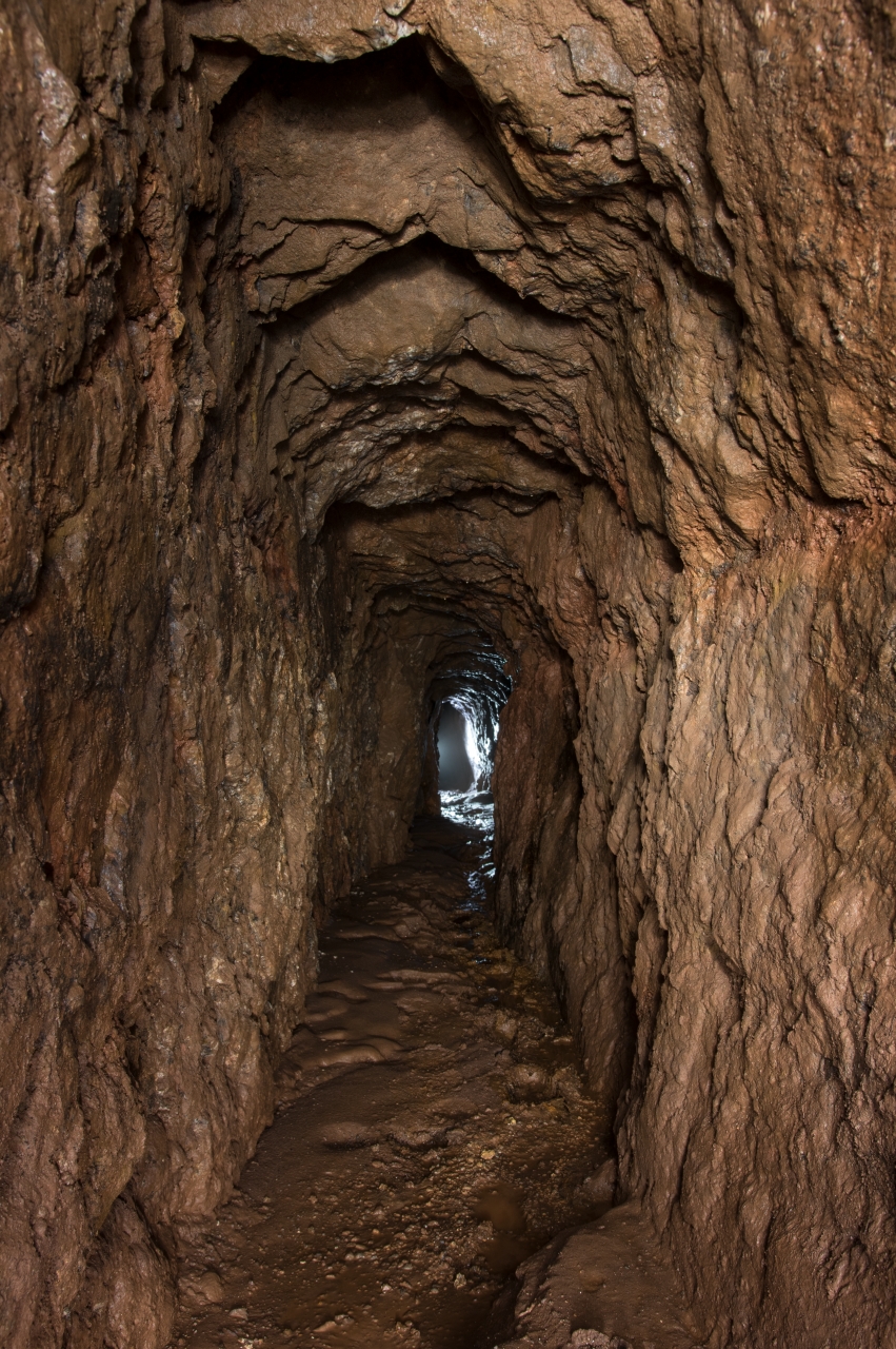 Enger vorindustrieller Stollen mit Gegenlicht