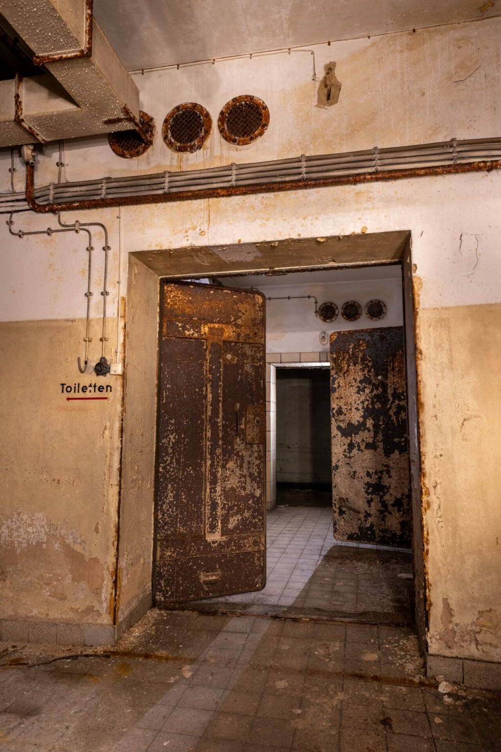 Blick auf die rostigen Flügeltüren der Gasschleuse.